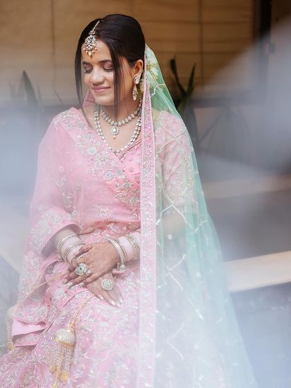 A dreamy, soft-focus portrait of a bride, her expression serene, with a beautiful light leak effect.