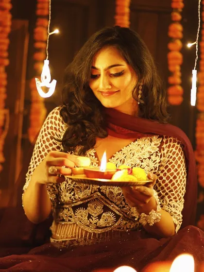 A festive shot featuring a traditional outfit and makeup. The look is elegant and perfect for celebrating Diwali with family and friends.