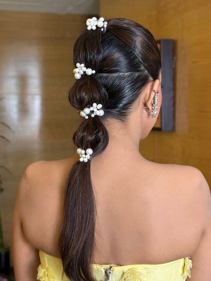 Another shot of the pearl-accessorized bubble braid, perfect for a day-time wedding event.