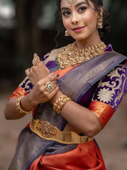 The intricate embroidery on the purple blouse adds another layer of artistry to this stunning ensemble.