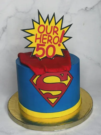 A Superman-themed cake for a 50th birthday, because dads are heroes too. The bold colors, iconic logo, and flowing cape make this a powerful and fun centerpiece for a milestone celebration.