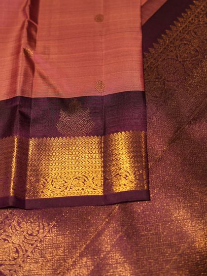 The contrast between the pink body and the brocade violet pallu makes this a truly special piece for any bride.