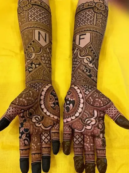 A bold and beautiful bridal design incorporating the couple's initials in stylish shields. This is for the bride who wants to make a statement with her mehndi.
