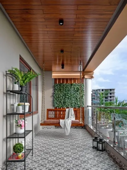 A beautiful balcony featuring a traditional wooden swing, patterned tile flooring, and a vertical green wall. This design combines classic comfort with modern elements to create a relaxing and stylish outdoor nook.