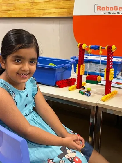 Our robotics journey starts as early as kindergarten. Here, one of our youngest students proudly displays the functional swing she built using a LEGO robotics kit, demonstrating how we make fundamental engineering concepts accessible and fun from day one.