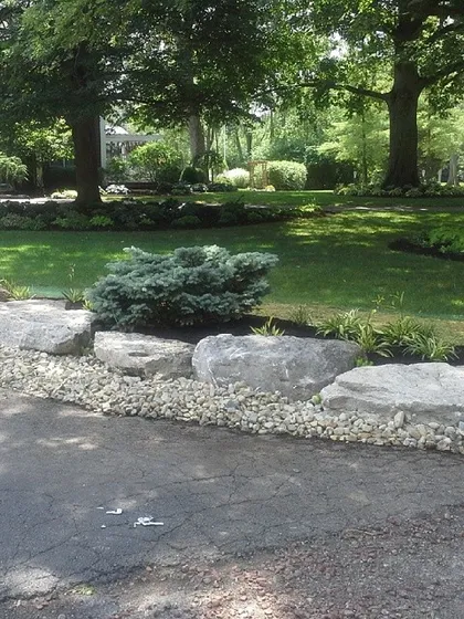 Sometimes it’s the details along the driveway that make a big difference. I used these large boulders and river rock to create a solid, low-maintenance border that adds a lot of character.