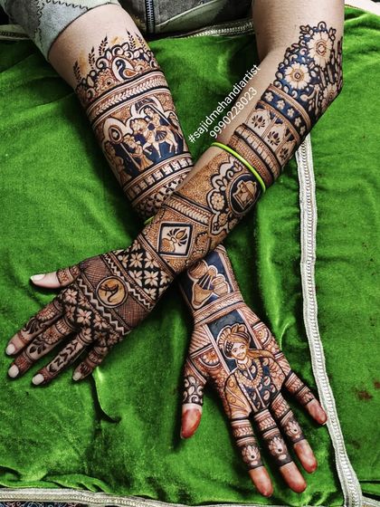 A unique take on bridal mehandi, this design uses negative space and color accents to make the portraits pop. The artwork includes scenes of the couple and traditional Rajasthani motifs.