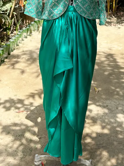 The draped skirt creates a beautiful silhouette that is both modern and elegant.