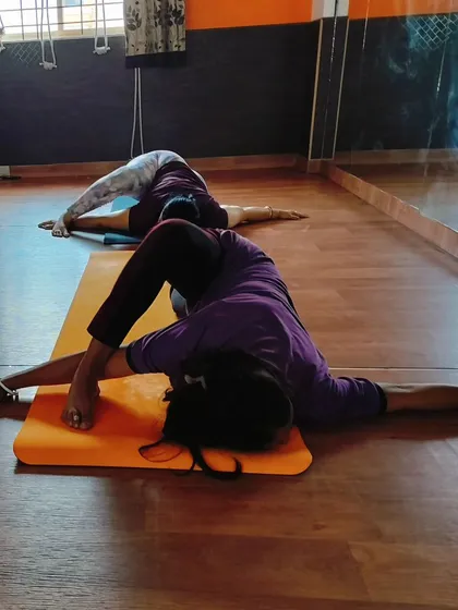 Students practicing a variation of Pristhanasana, the Crawling Lizard pose. This is an intense hip opener that stretches the hip flexors, glutes, and hamstrings.