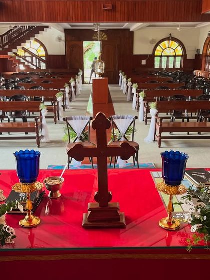 A view from the altar of a church decorated for a wedding. I provide simple and elegant decorations for the pews and the altar to create a serene and beautiful environment.