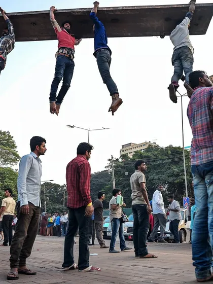 Another scene from 'a moment of lightness in mumbai', where a group of men appear to be floating while carrying a large plank. I use these images to disrupt the viewer's sense of reality.