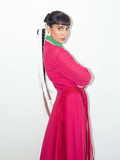 A final pose in the vibrant pink Bodice dress, showcasing a confident and colorful personal style.