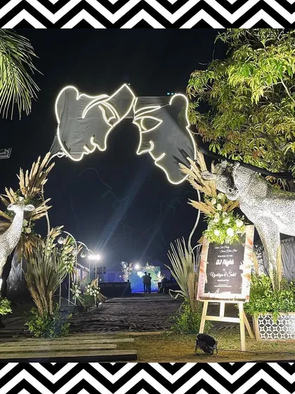 The entrance for our black and white themed Sangeet featured a custom neon sign of the couple's faces, creating a personalized and trendy welcome.