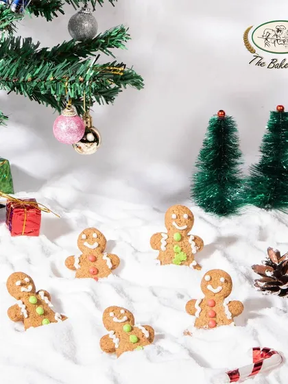 Our gingerbread men cookies, playfully arranged in a snowy scene. These are a fun and traditional treat for the holiday season.