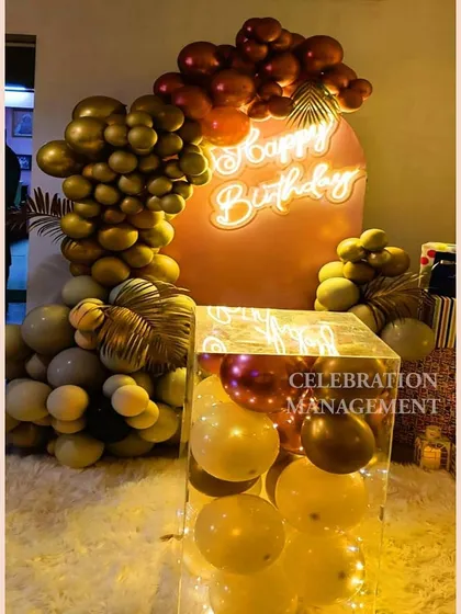 The 'Happy Birthday' neon sign glows warmly against the pink backdrop, tying the whole color scheme together.