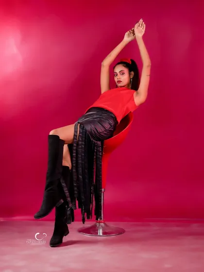 A powerful and elegant pose with arms raised. The composition is dramatic and full of grace.