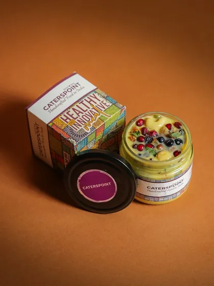 A close-up of our innovative and healthy fruit custard, beautifully packaged and ready to be enjoyed. It's a spoonful of sunshine in a jar.
