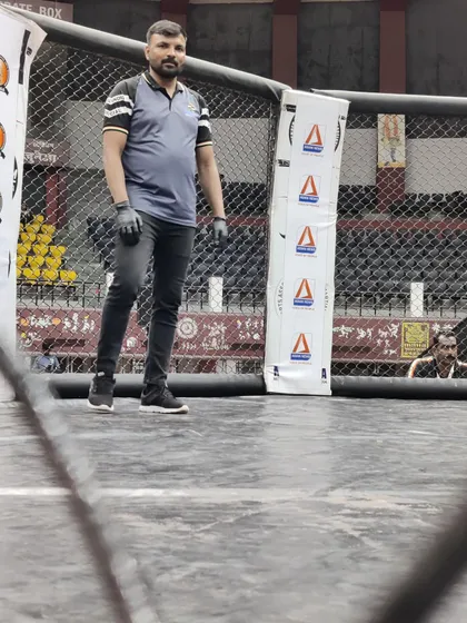 Another shot of me refereeing a bout at the national championship. Ensuring a fair and safe fight is my top priority.