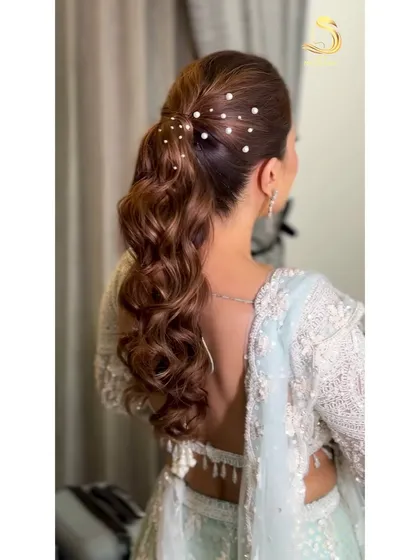 The final look: a gorgeous textured ponytail with scattered pearls, perfect for a bridesmaid or cocktail event.