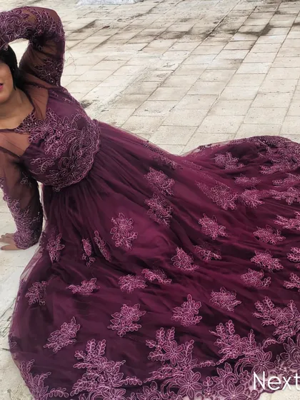 A dramatic, artistic pose on the floor, highlighting the full spread of the gorgeous gown.