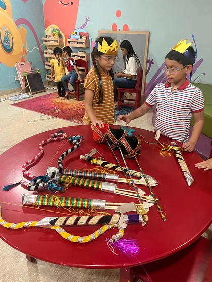 Children examining the props for the Ramleela. This hands-on approach helps them connect more deeply with the story and their characters.