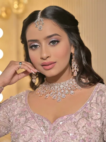 A close-up of the pastel bridal look, showing the delicate eye makeup and the flawless, glowing skin.