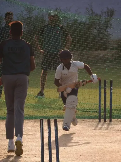 Running between the wickets is a skill we practice with intensity. This shot captures a batsman pushing for a quick single during an open net session.