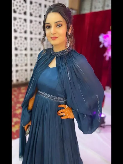 The client looking stunning in her reception outfit, her hair styled to perfection.