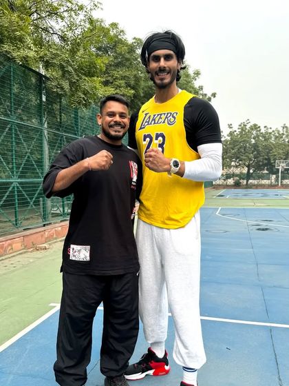 Standing with a 6'8" multi talented athlete. It's exciting to work with players from different backgrounds and help them achieve their basketball goals.