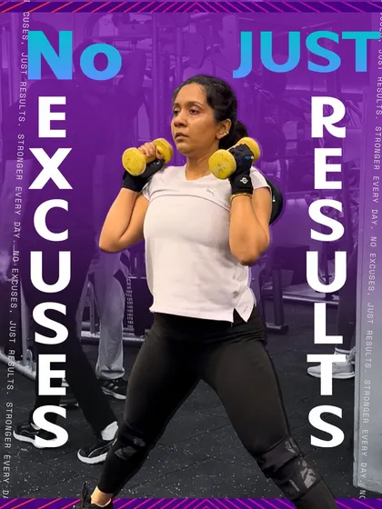 No Excuses, Just Results. A member demonstrates her strength and determination with dumbbell squats.