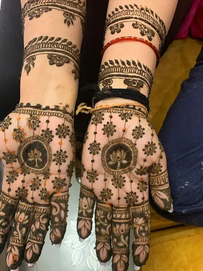 A symmetrical design for both hands, centered around the peaceful lotus motif. This style combines traditional floral patterns with a clean, modern feel, extending up the wrists with delicate vine work.