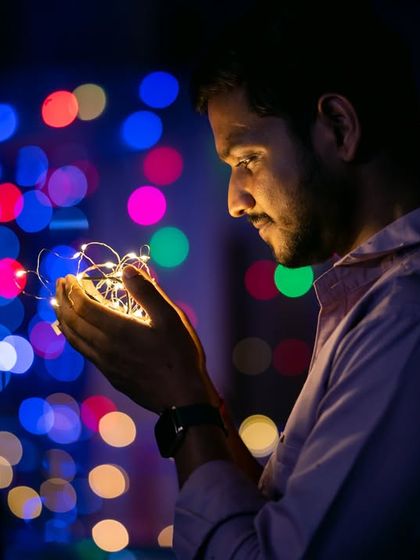 A creative portrait for Diwali, using the bokeh from colorful lights to create a magical background.