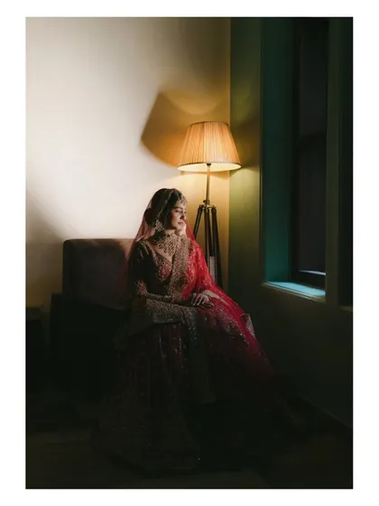 A bride's quiet contemplation in the soft glow of a lamp before her Nikah ceremony. This moody, fine-art portrait captures the soulful anticipation and elegance of the moment, turning a fleeting feeling into a timeless piece of art.