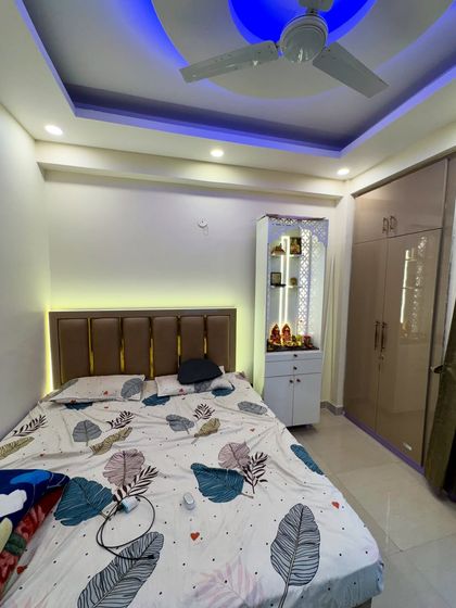 The bedroom from the 2BHK project, which includes a compact pooja unit.