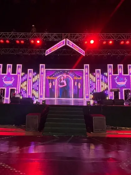 A stage fit for a Bollywood-themed sangeet night. The LED backdrop features vibrant, custom graphics and is framed by theatrical lighting, creating the perfect set for dazzling dance numbers.