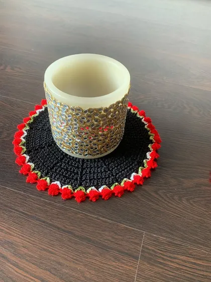 A black doily with a red tulip border, a bold and dramatic color combination that makes a strong statement.