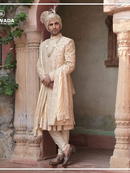 This image captures the groom in a moment of reflection, his attire speaking volumes. The detailed embroidery on the sherwani is a testament to the artistry of the Shauhar collection.