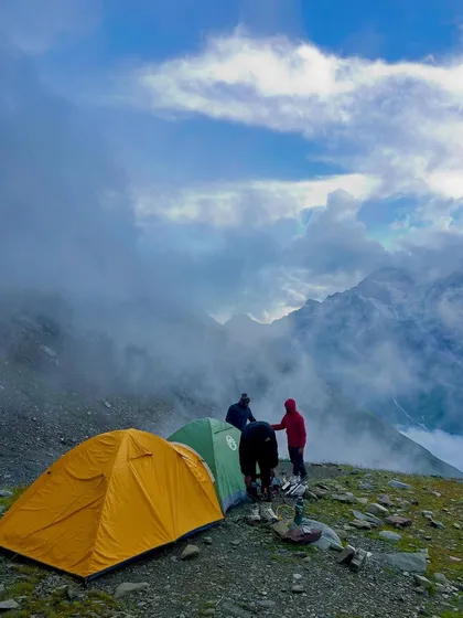 Our campsite on Friendship Peak, pitched on a high ridge with clouds rolling in below. This is what high-altitude camping looks like.