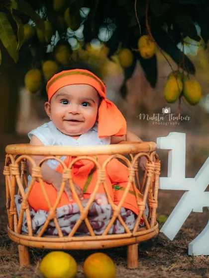 A beautiful, smiling portrait to celebrate six months. The natural backdrop of the mango grove is simply stunning.
