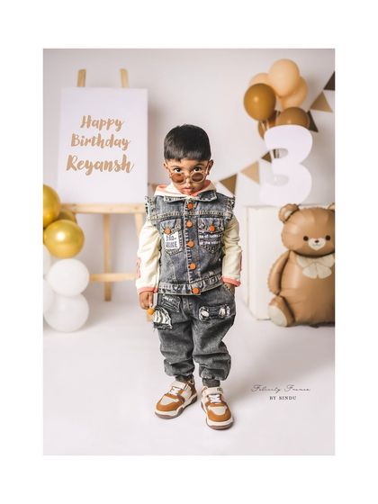 This three-year-old has so much style! His denim outfit and cool shades make for a very memorable third birthday portrait.