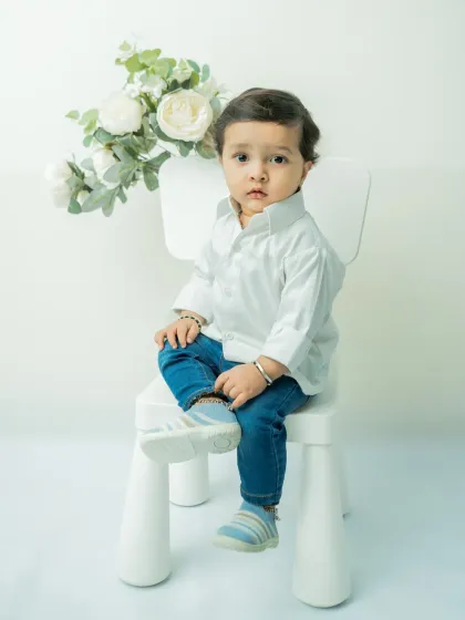 Beyond themes, I specialize in clean, classic portraits. This pre-birthday shoot uses a simple white background to focus entirely on the baby's curious expression and milestone of sitting up, creating a timeless memory.