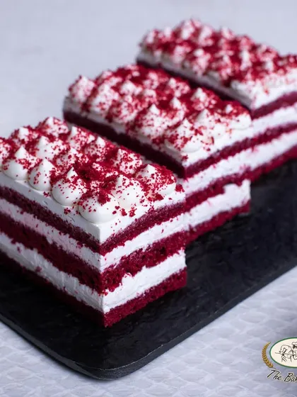 A closer look at our layered Red Velvet Pastry, showing the perfect ratio of cake to cream cheese frosting.