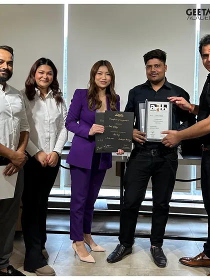 Our leadership team personally congratulates a graduate, awarding him his certificate of completion. This signifies his readiness to excel in the professional salon industry.