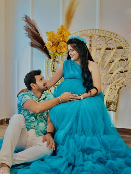 A quiet moment of connection between partners during their maternity shoot. Our popular boho-themed setup with the peacock chair provides a warm and relaxed backdrop for capturing these intimate memories.