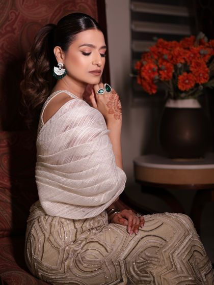 A close-up of the client's poised look in the ivory sharara set, a truly timeless and captivating style.