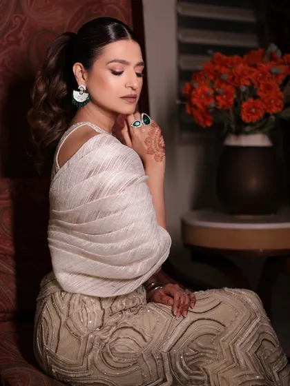 A close-up of the client's poised look in the ivory sharara set, a truly timeless and captivating style.