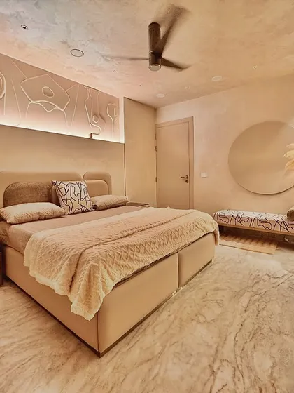 This bedroom is a retreat from the world, wrapped in the warmth of lime-washed walls and soft, ambient light. I designed a custom bas-relief art piece above the bed that interacts with the hidden lighting, creating subtle shadows and depth. The space is intentionally minimalist, using a neutral color palette and natural textures like the marble floor and soft textiles to promote rest and serenity.