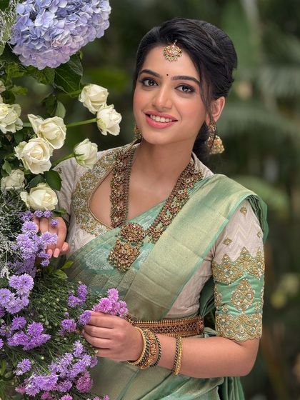 A smiling portrait of the bride, looking directly at the camera. Her makeup is fresh and enhances her natural beauty.