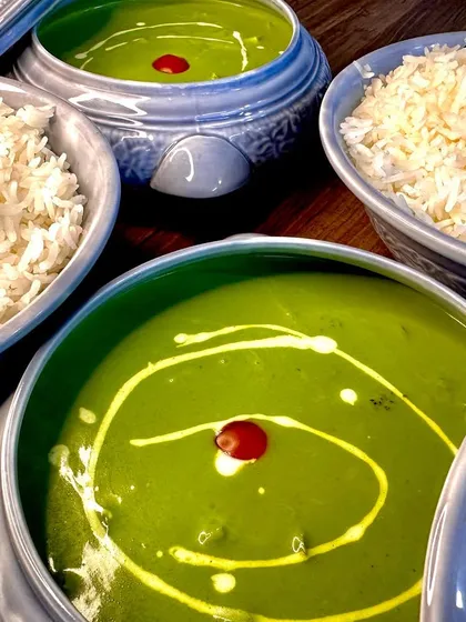 A close-up shot of the creamy swirl in my Thai Green Curry, garnished with a single red chili for a pop of color. It's all in the details.