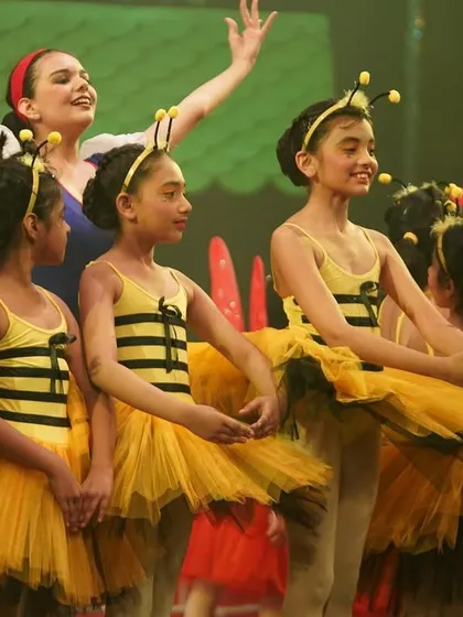Snow White with her bee friends. Our productions often feature large ensemble pieces that teach our students how to dance as a cohesive group.